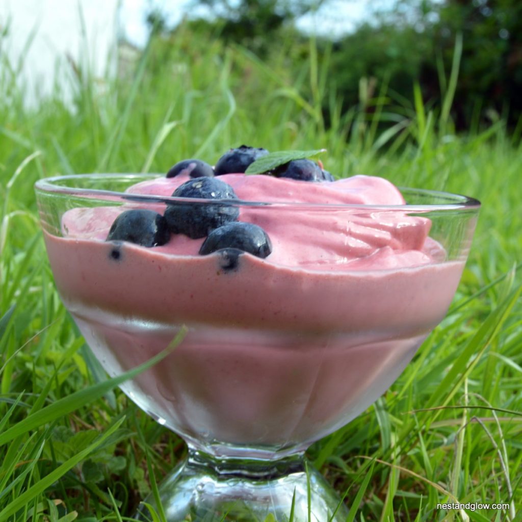 Healthy dairy free cashew ice cream made without refined sugar and sweetened just with fruit. Strawberry ice cream topped with blueberries and mint