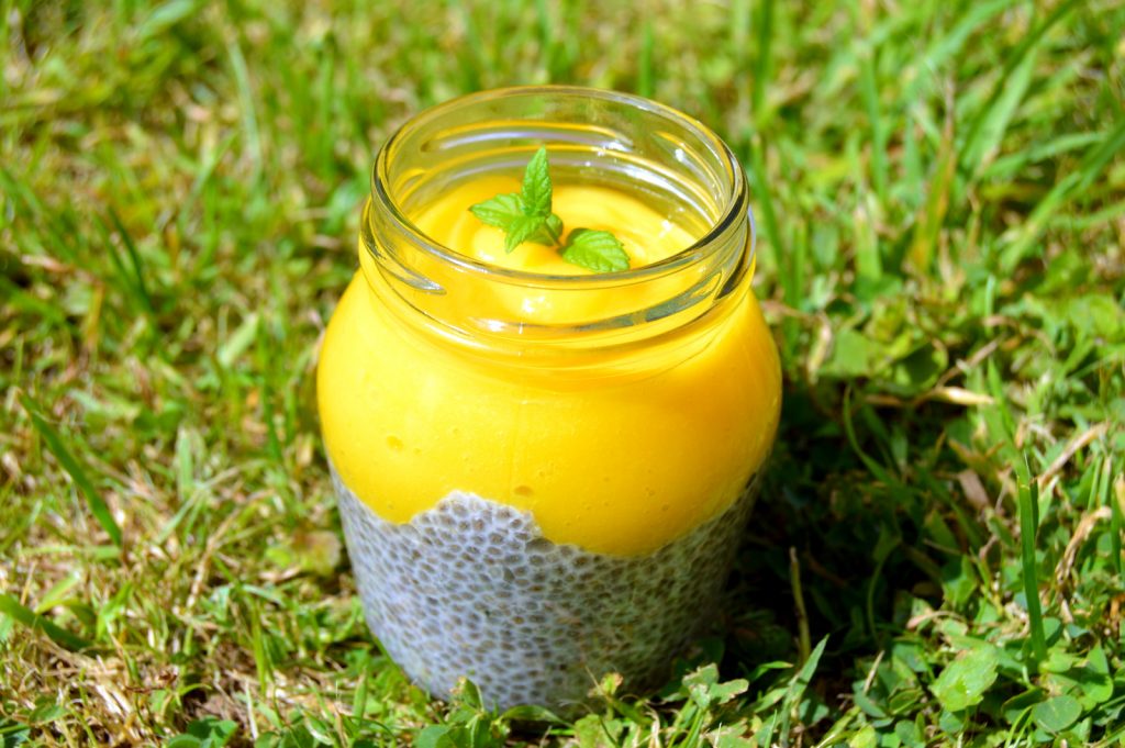 Easy Mango Lime Chia Pudding recipe topped with a mint leaf for decoration. This chia pudding is easy to make and any milk can be used