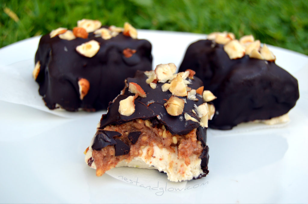 snickers ice cream bars recipe that tastes so good no one will know it's dairy and refined sugar free. coated in dark chocolate and sprinkles with hazelnuts, although any nut on top is great