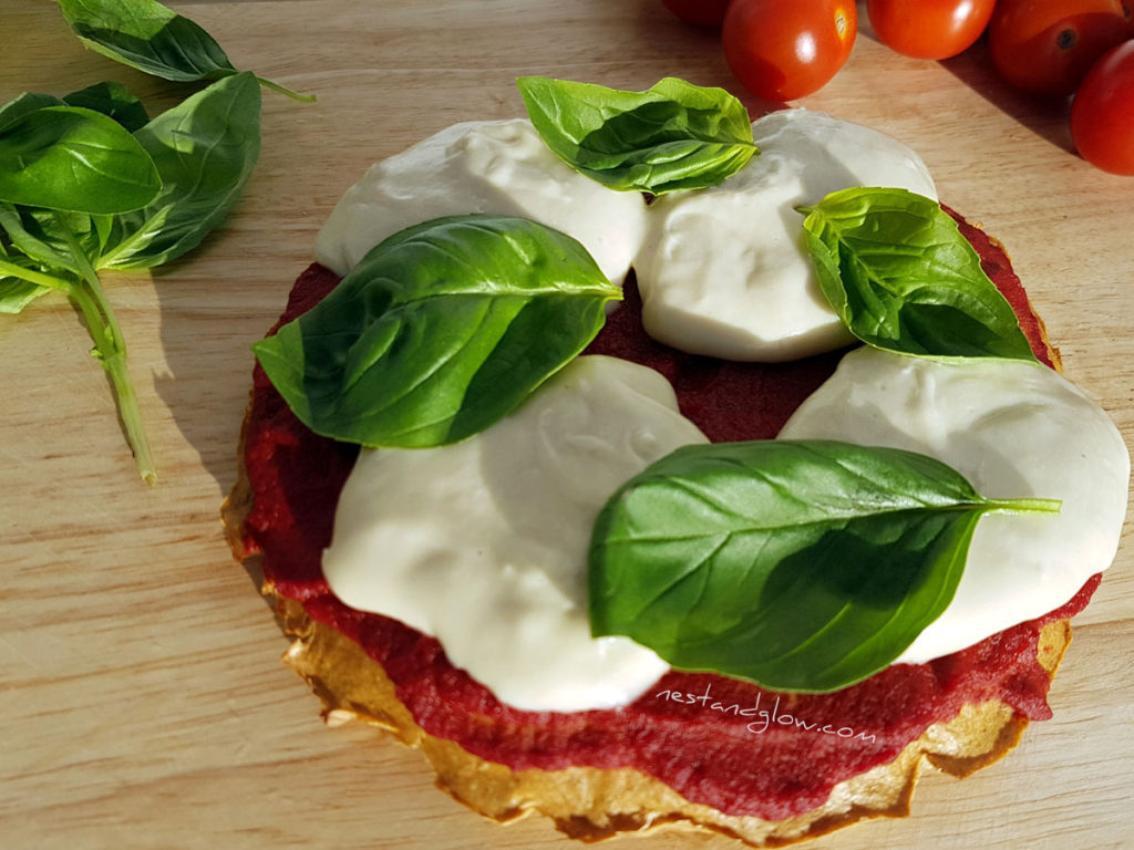 cashew mozzarella quinoa crust with fresh tomatoes and basil