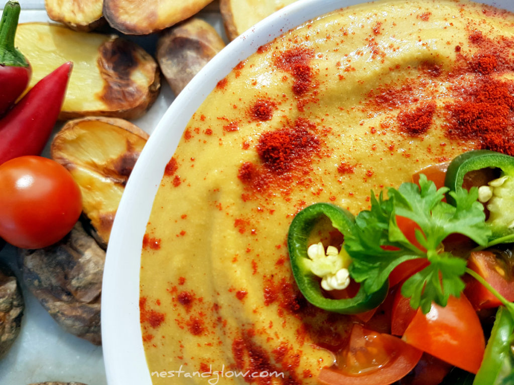 Light vegan Queso Cheese Dip topped with paprika, chilli and tomatoes