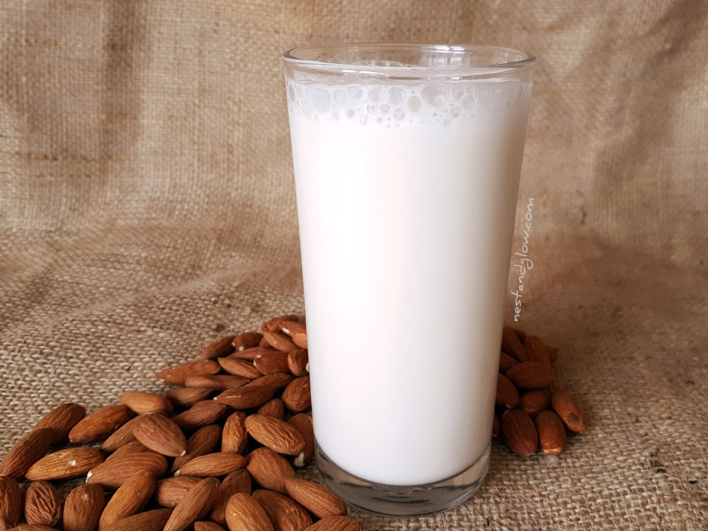 A glass of easy almond milk that's had a touch of natural sweetness and vanilla added. This simple almond milk is so versatile to use and a great way to save money