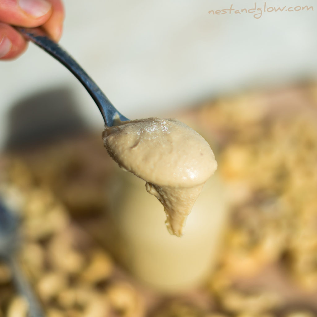 Cashew nut butter dripping off a spoon