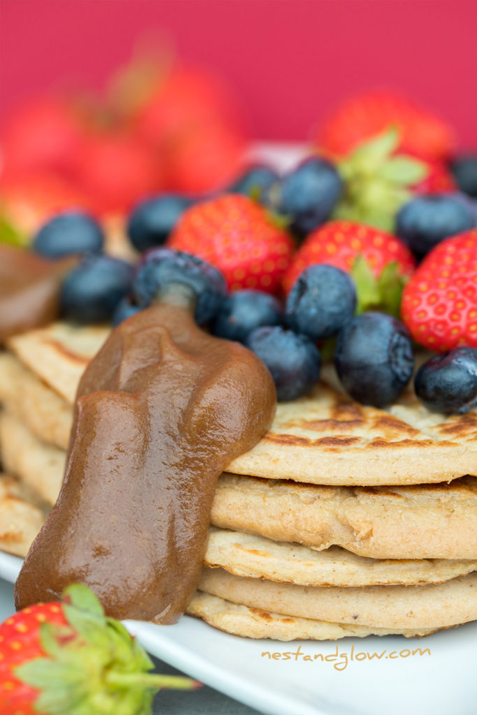 blueberry and strawberry on top of protein vegan pancakes. You can use any fruit you like to top these protein pancakes but fresh berries look and taste amazing
