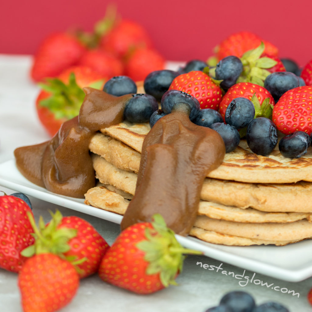 flour free protein pancakes topped with fresh berries and with some date syrup. these healthy protein pancakes are inexpensive to make and loaded with goodness.
