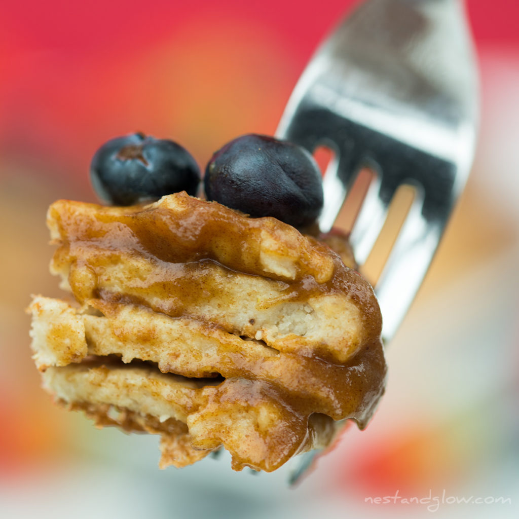 protein pancakes on a fork with date syrup. these light fluffy protein pancakes are vegan with no added egg, butter, flour or milk