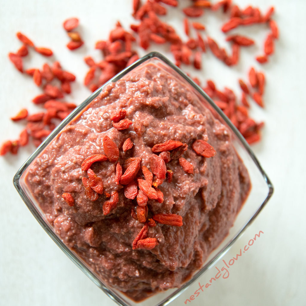red velvet healthy dessert hummus topped with goju berries. a bowl of this hummus is a meal in one and can be enjoyed with just a spoon!