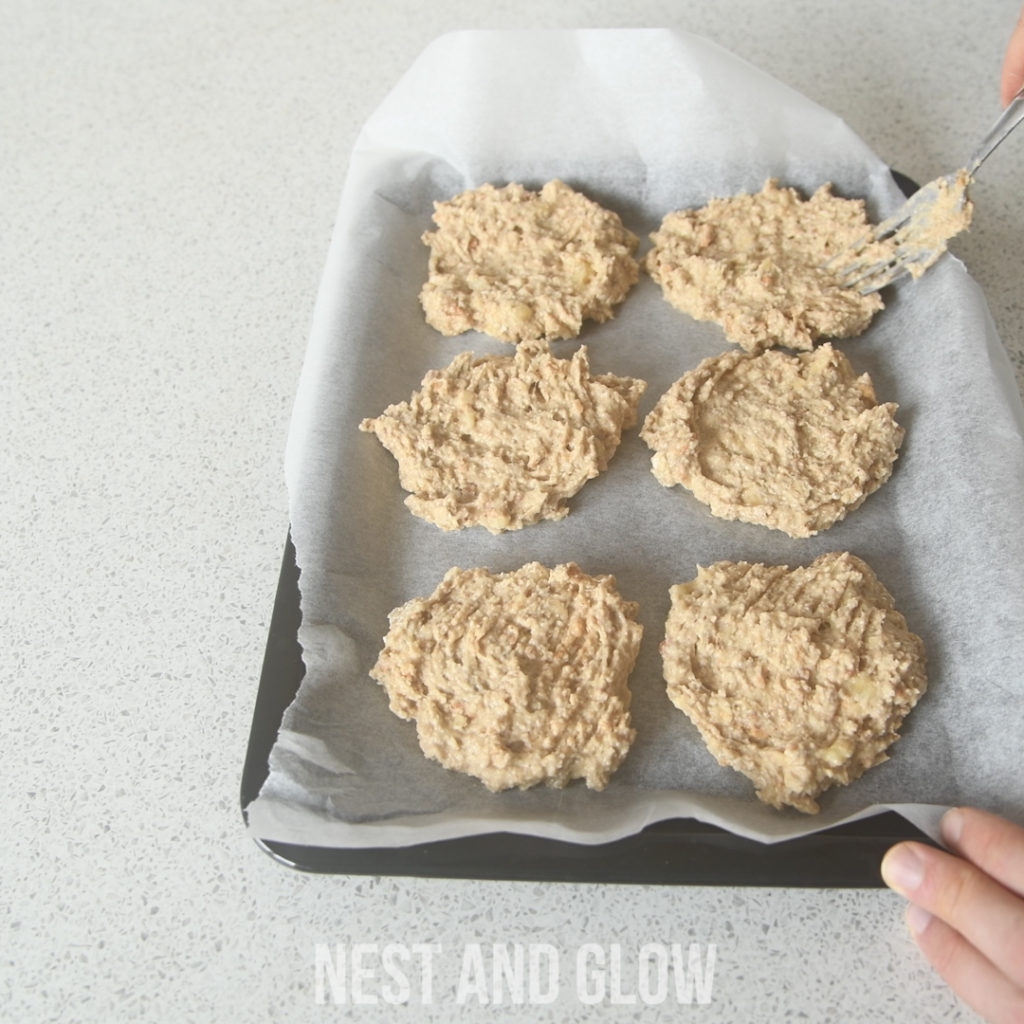 spreading out the healthy cookie dough using peanut butter to make a uniform shape for even baking