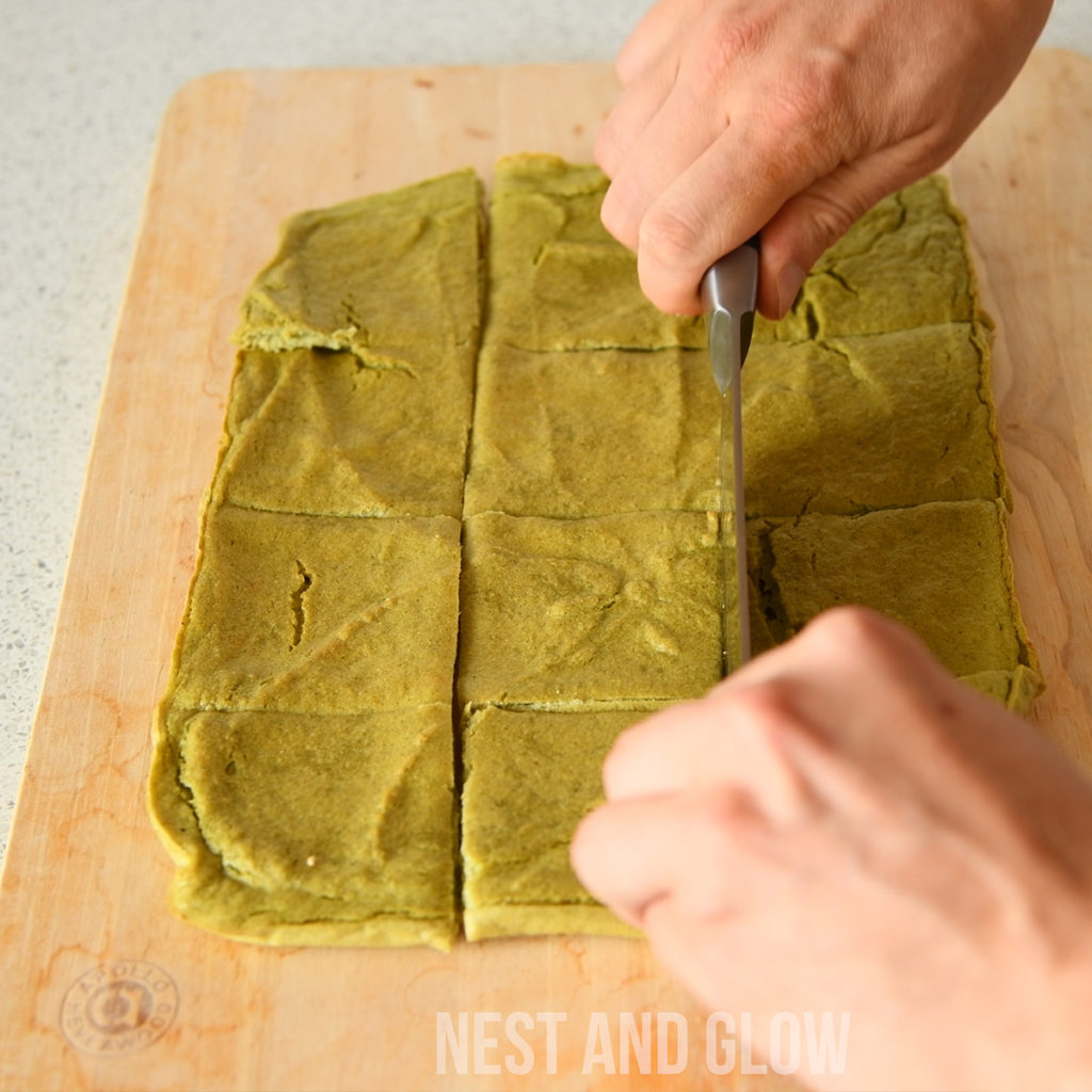 cutting quinoa broccoli bread. the gluten free bread is soft but still holds it shape