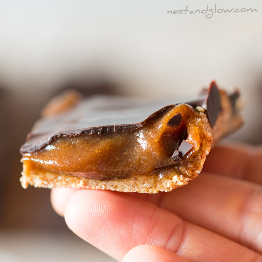 a slice of healthy caramel shortbread that's vegan, flour free no bake and easy to make