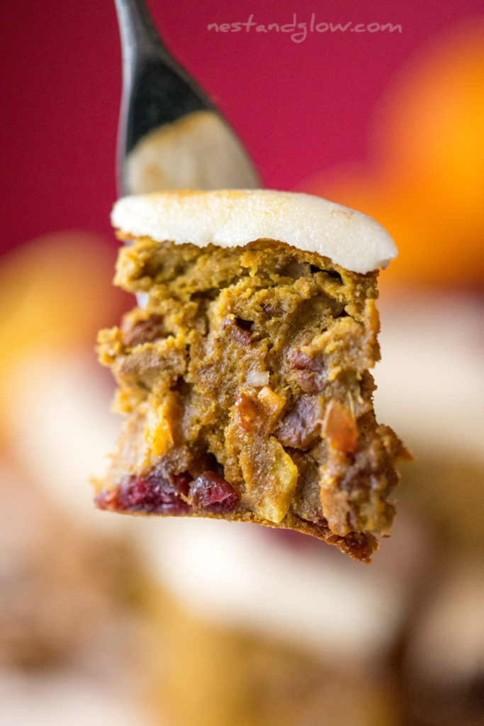 iced healthy fruit cake on a fork. this christmas cake is made from fruit, nuts and quinoa