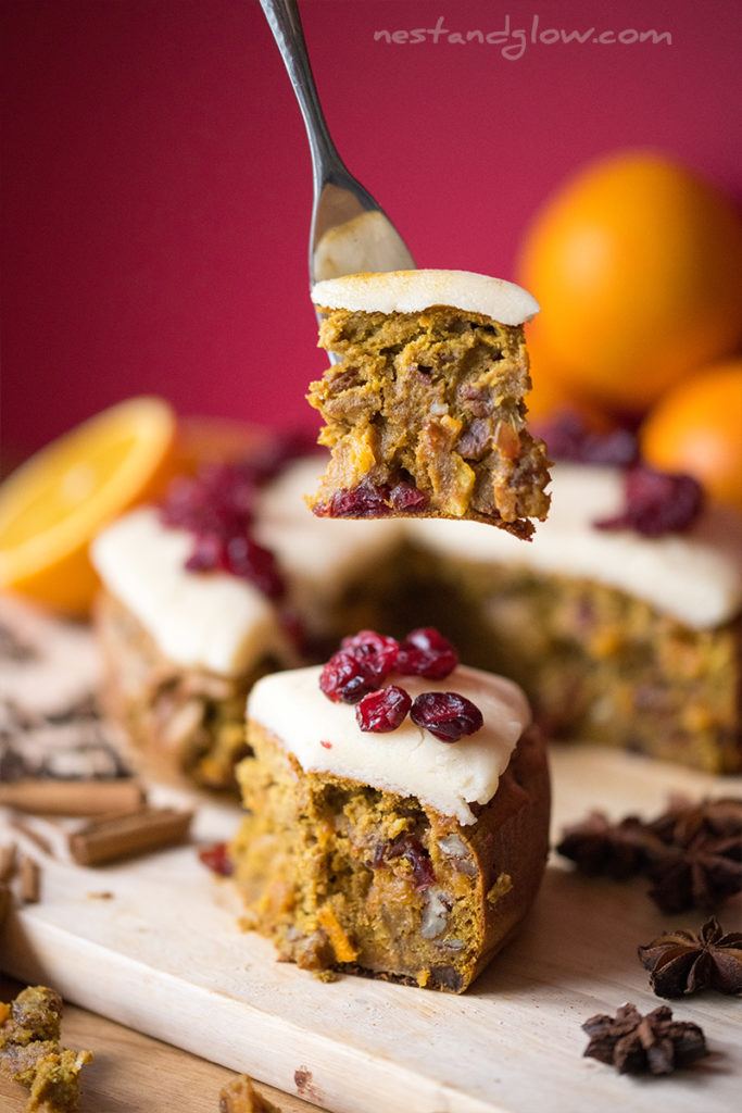 piece of quinoa christmas fruit cake on a fork. this healthy cake is topped with almond marzipan and dried cranberries
