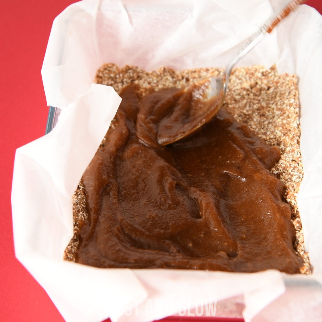 spreading date caramel over a healthy shortbread base. this recipe is cheap to make and high in nutrition.