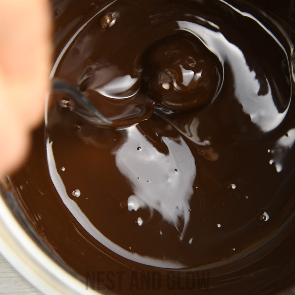 roll cranberry balls in melted chocolate