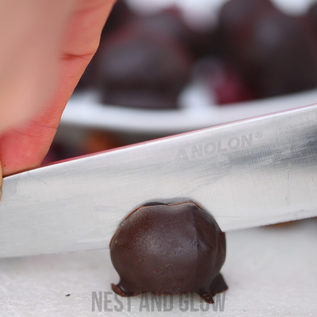cutting open a cranberry chocolate ball