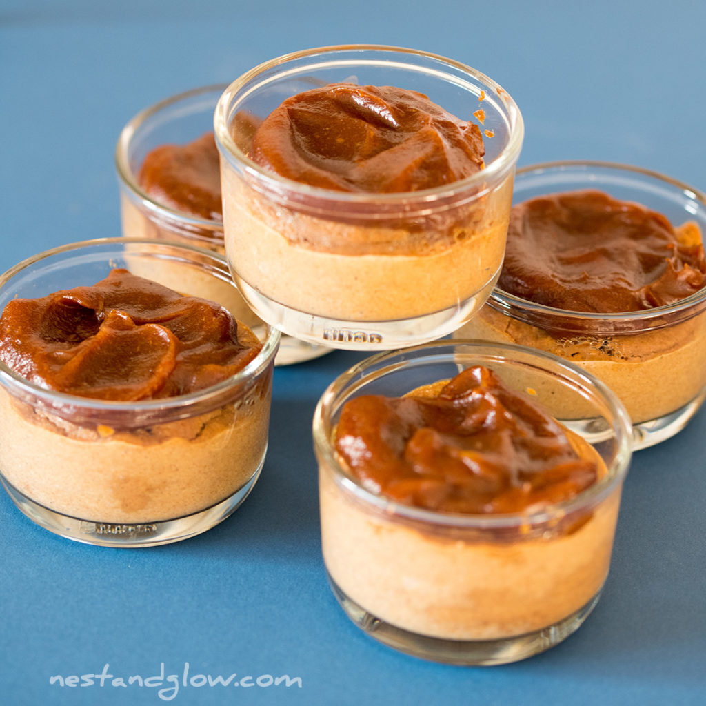 a stack of healthy sticky toffee puddings that are topped with a thick layer of date caramel. Made without refined sugar, eggs and oil so full of goodness.