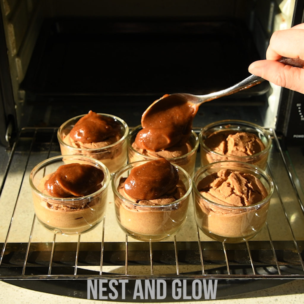 topping baked healthy sticky toffee puddings with date caramel.