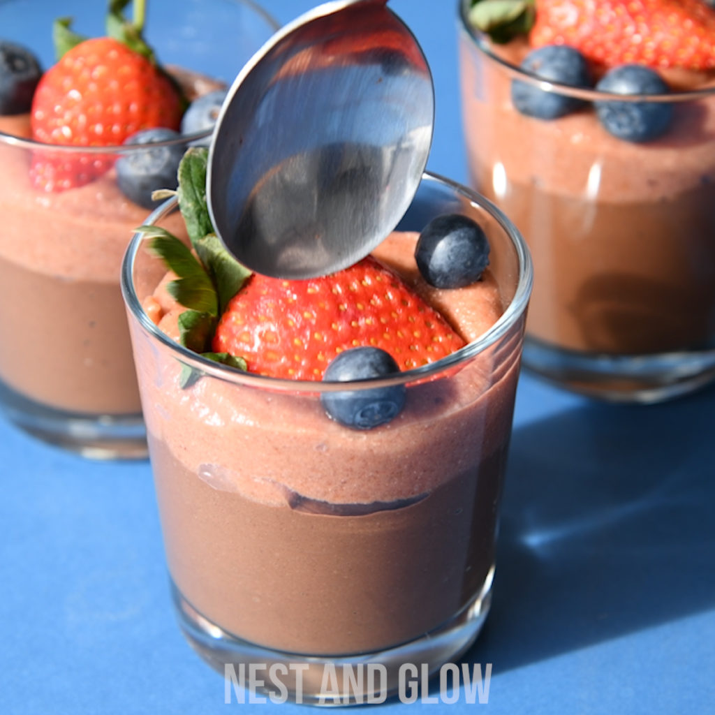 a spoon going into a simple and easy chocolate mousse recipe. made with just fruit and nuts